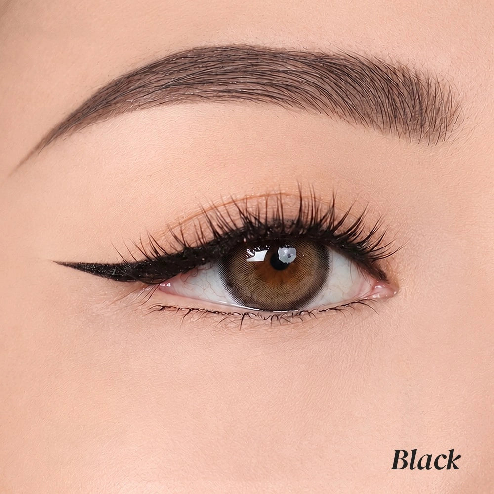 Close-up of a model's eye showcasing a sharp, winged black eyeliner look with long lashes and a defined eyebrow, with the word 'Black' in the bottom right corner.